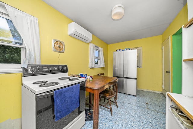 4 Traders Ct, Norwich, CT 06360 - kitchen featuring white electric range, freestanding refrigerator, a wall mounted AC, and light floors