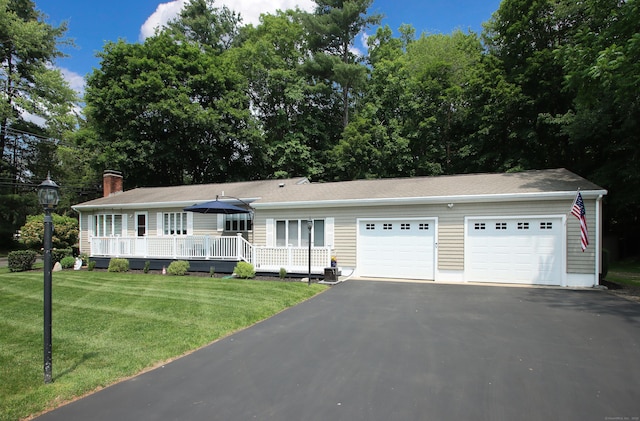 4 White Birch Dr, Guilford, CT 06437 - ranch-style home with a front lawn, a chimney, a deck, a garage, and driveway
