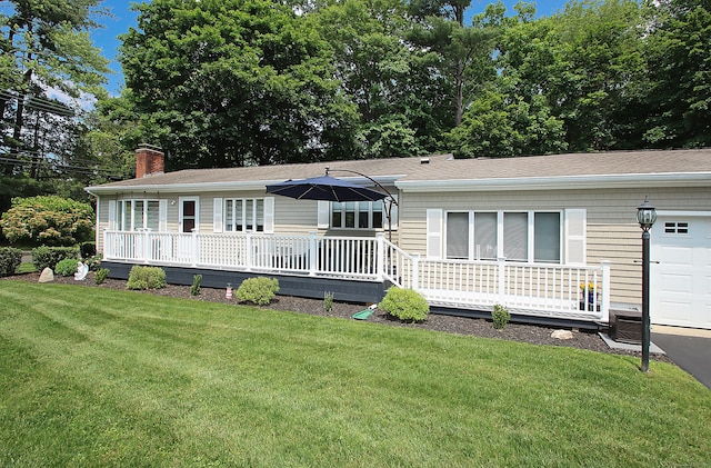 4 White Birch Dr, Guilford, CT 06437 - view of front facade featuring a front lawn, a chimney, a wooden deck, and a garage
