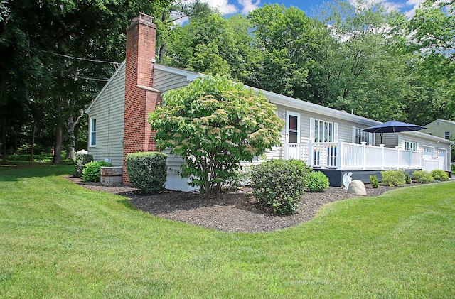 4 White Birch Dr, Guilford, CT 06437 - view of property exterior with a chimney, a lawn, and a deck