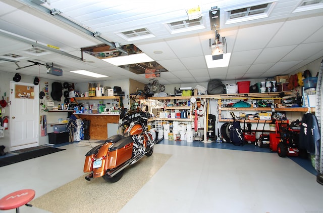4 White Birch Dr, Guilford, CT 06437 - garage featuring a workshop area and a garage door opener