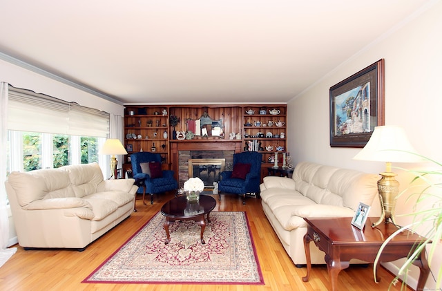 4 White Birch Dr, Guilford, CT 06437 - living room featuring crown molding, light wood-style floors, and a stone fireplace