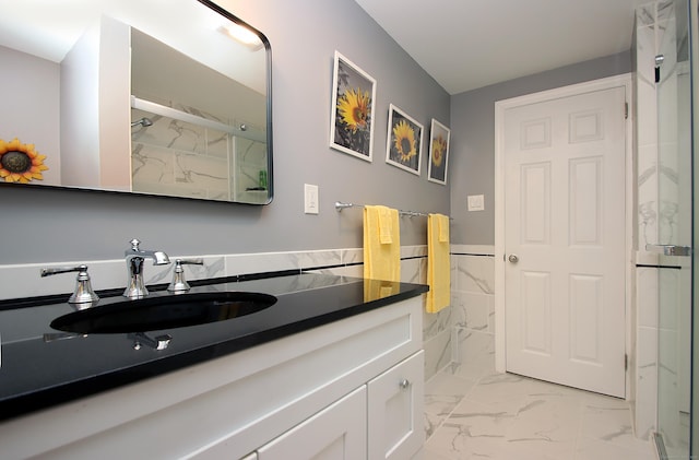 4 White Birch Dr, Guilford, CT 06437 - full bathroom featuring vanity, marble look tiles, a marble finish shower, and a wainscoted wall