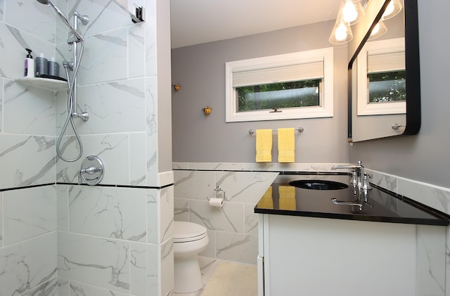 4 White Birch Dr, Guilford, CT 06437 - bathroom featuring vanity, a marble finish shower, tile walls, and a wainscoted wall