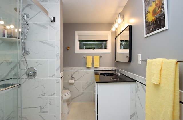 4 White Birch Dr, Guilford, CT 06437 - bathroom with a marble finish shower, vanity, a wainscoted wall, and tile walls