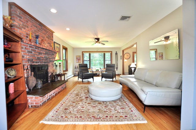 127 Weldon Ct, Goshen, CT 06756 - living room with a ceiling fan, wood finished floors, recessed lighting, a baseboard heating unit, and a brick fireplace