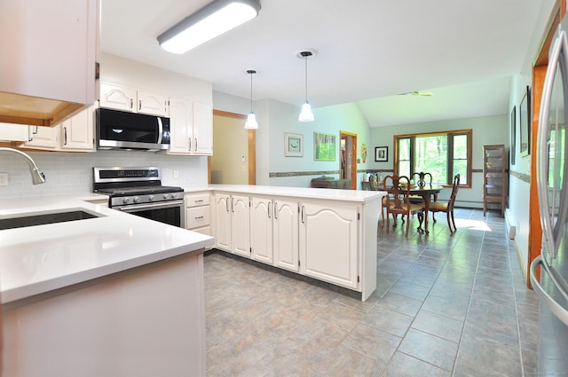 127 Weldon Ct, Goshen, CT 06756 - kitchen featuring stainless steel appliances, backsplash, a peninsula, white cabinetry, and light countertops