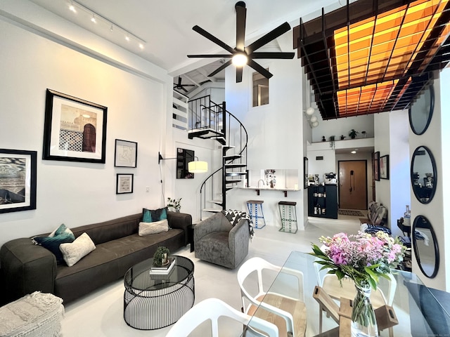 125 Washington St Apt 306, Norwalk, CT 06854 - living room featuring a ceiling fan, stairs, rail lighting, and a towering ceiling