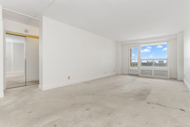 71 Strawberry Hill Ave Apt 1002, Stamford, CT 06902 - unfurnished bedroom with baseboards and carpet floors