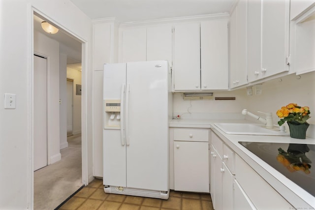 71 Strawberry Hill Ave Apt 1002, Stamford, CT 06902 - kitchen with white refrigerator with ice dispenser, black electric stovetop, light countertops, and white cabinetry