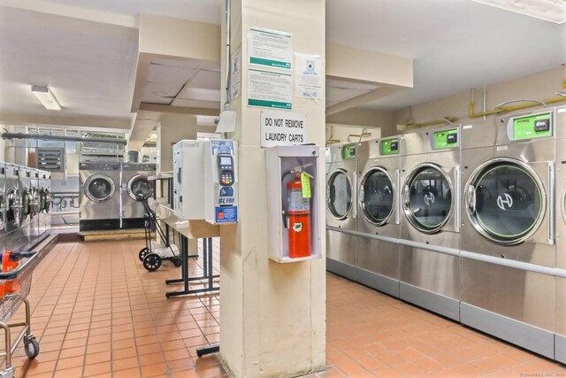 71 Strawberry Hill Ave Apt 1002, Stamford, CT 06902 - shared laundry room with washer and dryer and tile patterned flooring