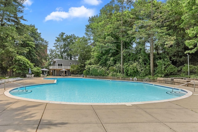 71 Strawberry Hill Ave Apt 1002, Stamford, CT 06902 - community pool with view of scattered trees and a patio area