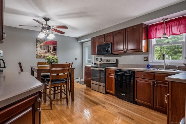 309 Russo Dr, Hamden, CT 06518 - kitchen with black appliances, a ceiling fan, light wood-style flooring, and baseboard heating