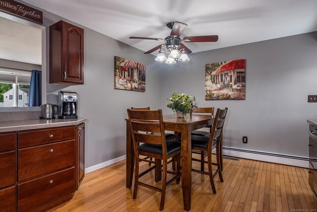 309 Russo Dr, Hamden, CT 06518 - dining space with a ceiling fan, a baseboard heating unit, and light wood finished floors