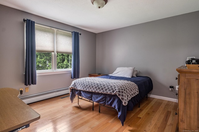 309 Russo Dr, Hamden, CT 06518 - bedroom with baseboard heating and wood-type flooring