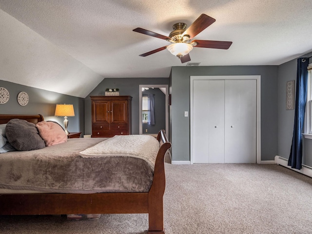 309 Russo Dr, Hamden, CT 06518 - carpeted bedroom featuring a textured ceiling, a closet, ceiling fan, vaulted ceiling, and a baseboard radiator