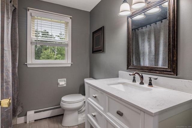 309 Russo Dr, Hamden, CT 06518 - full bath with a baseboard heating unit, vanity, and wood finished floors