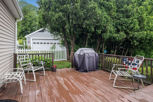 309 Russo Dr, Hamden, CT 06518 - deck featuring grilling area, an outdoor structure, a detached garage, and view of wooded area