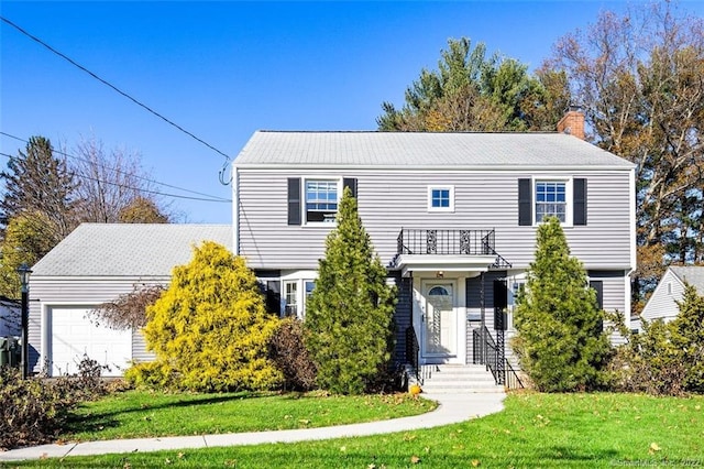 154 Mohawk Dr, West Hartford, CT 06117 - view of front of property with a balcony, a chimney, a front yard, and an attached garage