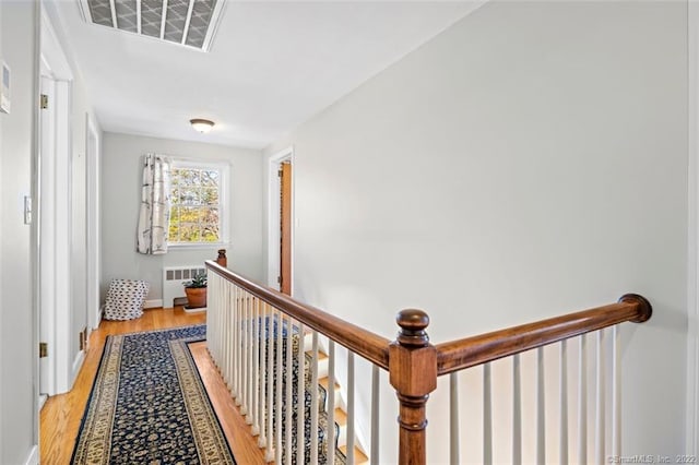 154 Mohawk Dr, West Hartford, CT 06117 - hall with radiator, an upstairs landing, and light wood-type flooring