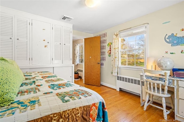 154 Mohawk Dr, West Hartford, CT 06117 - bedroom with radiator heating unit and light wood-type flooring