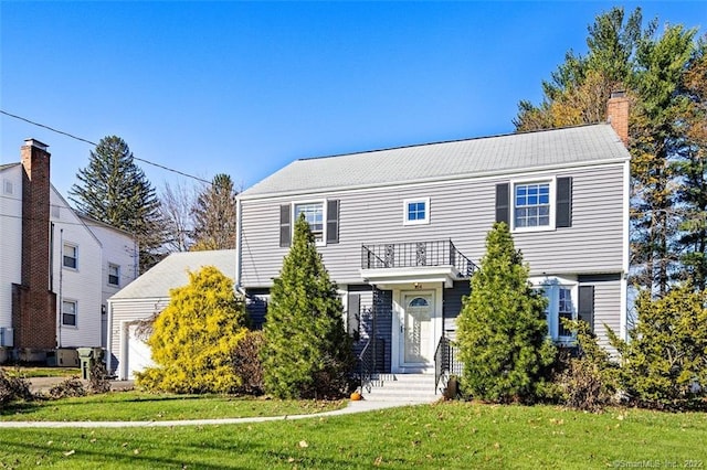 154 Mohawk Dr, West Hartford, CT 06117 - view of front of property with a balcony, a front yard, a chimney, and a garage