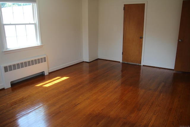 154 Mohawk Dr, West Hartford, CT 06117 - unfurnished room with radiator heating unit and hardwood / wood-style floors