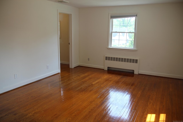 154 Mohawk Dr, West Hartford, CT 06117 - spare room with radiator heating unit and hardwood / wood-style floors
