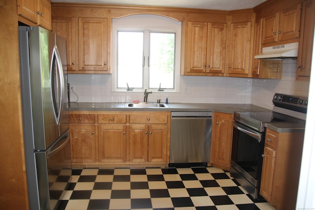 154 Mohawk Dr, West Hartford, CT 06117 - kitchen with stainless steel appliances, under cabinet range hood, light flooring, and brown cabinetry
