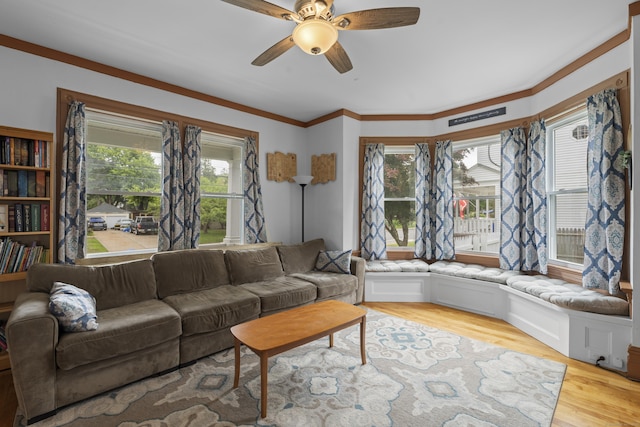 135 W Thames St, Norwich, CT 06360 - living area featuring plenty of natural light, ceiling fan, wood finished floors, and crown molding