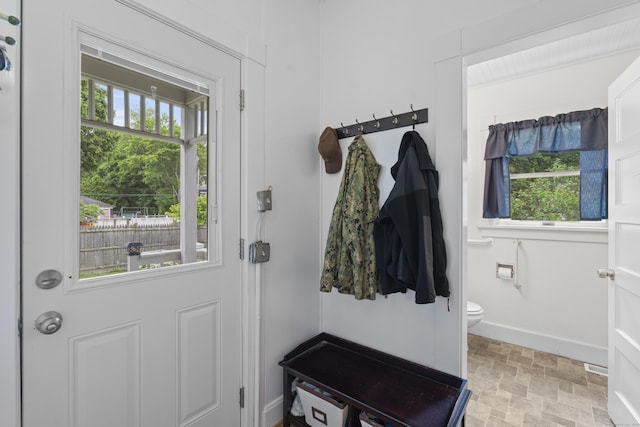 135 W Thames St, Norwich, CT 06360 - mudroom with plenty of natural light and light stone finish flooring