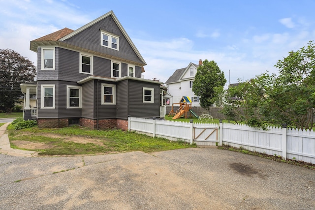 135 W Thames St, Norwich, CT 06360 - view of side of home featuring a gate and a playground