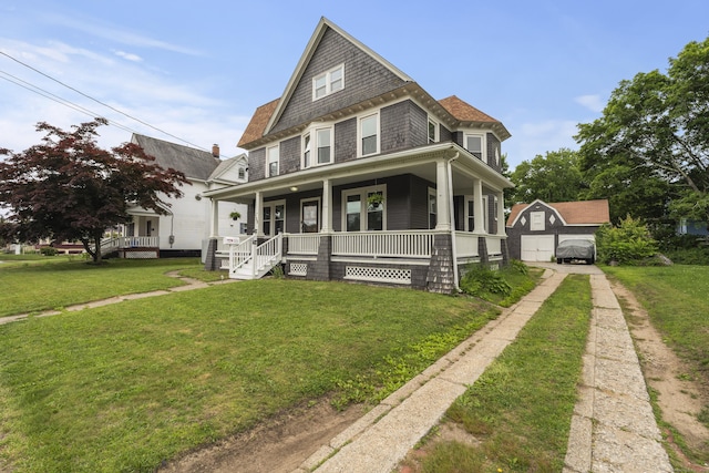 135 W Thames St, Norwich, CT 06360 - view of front facade featuring covered porch, a front lawn, and a detached garage