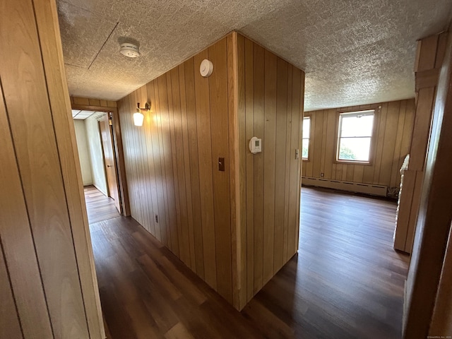 306 Divinity St, Bristol, CT 06010 - corridor with a baseboard radiator, dark wood-type flooring, and wood walls