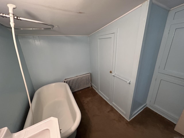 306 Divinity St, Bristol, CT 06010 - bathroom featuring radiator heating unit, lofted ceiling, and a freestanding tub