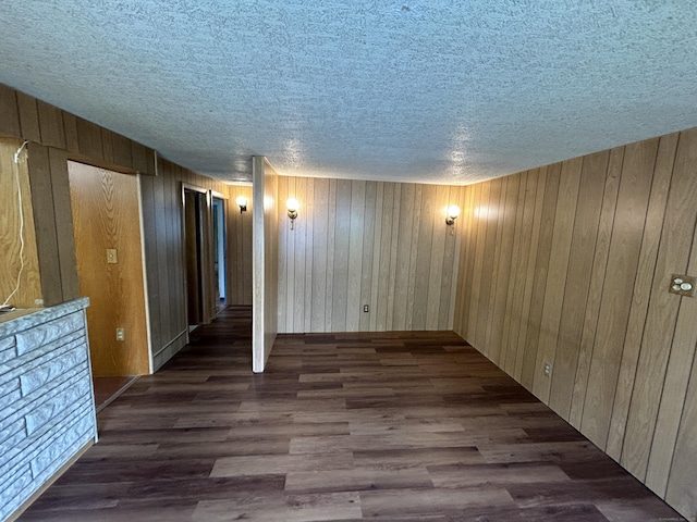 306 Divinity St, Bristol, CT 06010 - unfurnished living room featuring a textured ceiling, wood finished floors, and wooden walls