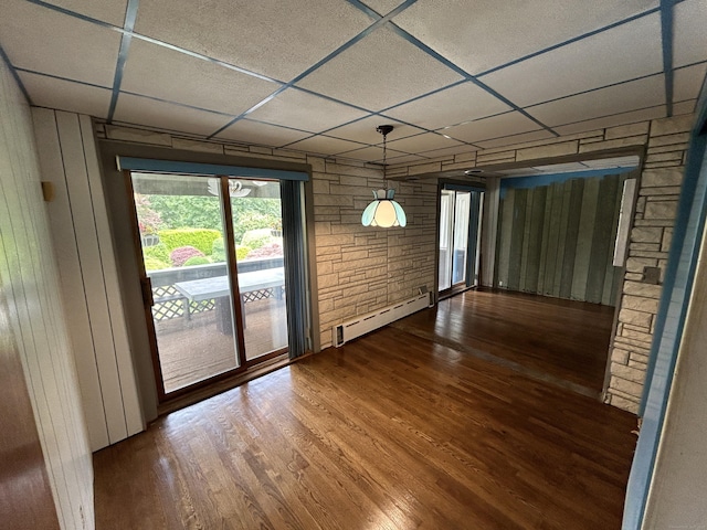 306 Divinity St, Bristol, CT 06010 - unfurnished dining area with a baseboard heating unit, wood finished floors, a paneled ceiling, and wood walls