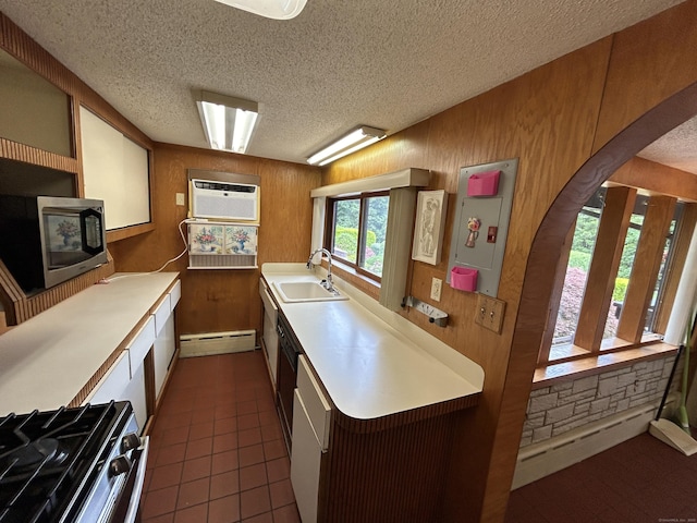 306 Divinity St, Bristol, CT 06010 - kitchen with appliances with stainless steel finishes, a baseboard radiator, a textured ceiling, light countertops, and an AC wall unit