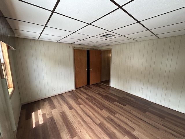 306 Divinity St, Bristol, CT 06010 - empty room with a paneled ceiling, wood finished floors, and wood walls