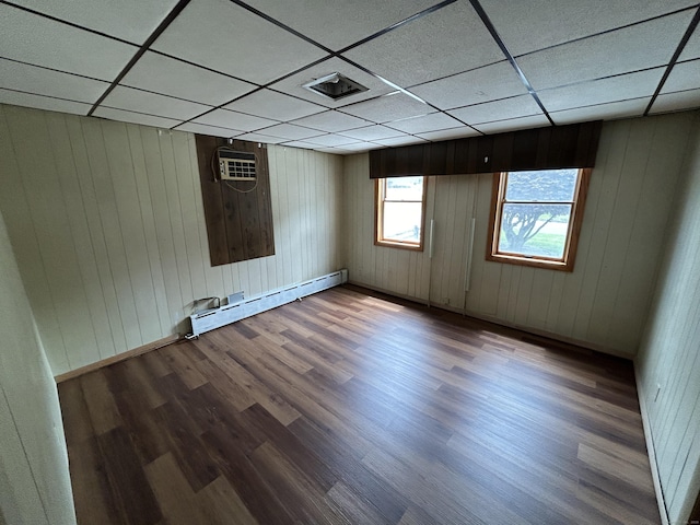 306 Divinity St, Bristol, CT 06010 - unfurnished room with wood finished floors, a paneled ceiling, baseboard heating, and wooden walls