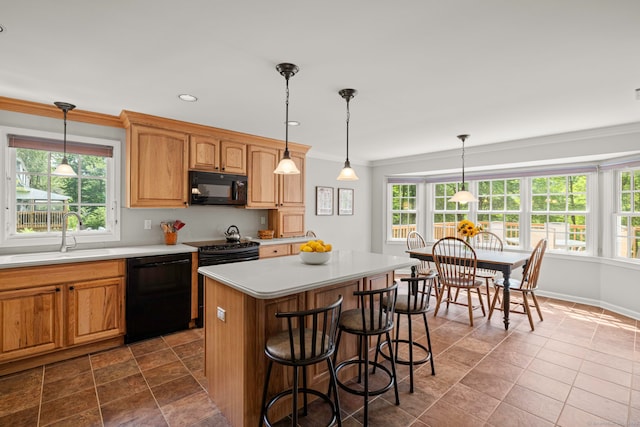 115 Remington Rd, Ridgefield, CT 06877 - kitchen with black appliances, light countertops, crown molding, healthy amount of natural light, and a kitchen island