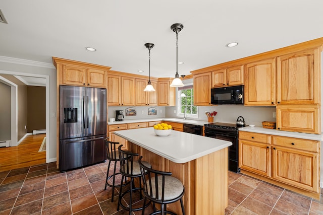 115 Remington Rd, Ridgefield, CT 06877 - kitchen featuring black appliances, a baseboard heating unit, light countertops, a kitchen island, and a breakfast bar