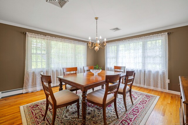 115 Remington Rd, Ridgefield, CT 06877 - dining area featuring a chandelier, crown molding, light wood finished floors, and baseboard heating