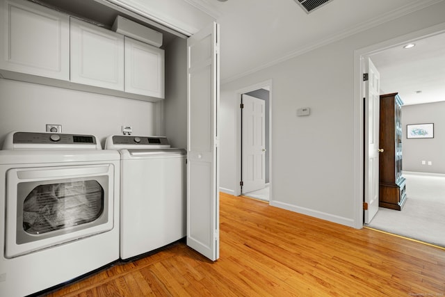 115 Remington Rd, Ridgefield, CT 06877 - laundry room featuring cabinet space, separate washer and dryer, ornamental molding, light wood-style floors, and recessed lighting