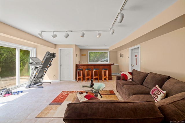 115 Remington Rd, Ridgefield, CT 06877 - living room with rail lighting, light tile patterned floors, a baseboard heating unit, and a bar