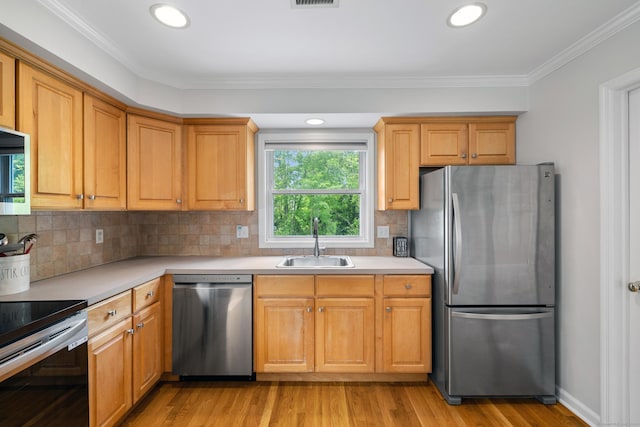 17 Glenwood Ave, Norwalk, CT 06854 - kitchen featuring stainless steel appliances, light countertops, light wood finished floors, backsplash, and crown molding