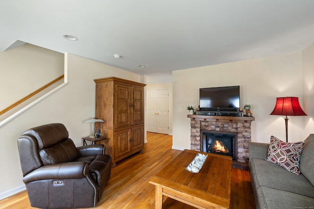 17 Glenwood Ave, Norwalk, CT 06854 - living room with light wood finished floors, a stone fireplace, stairway, and recessed lighting
