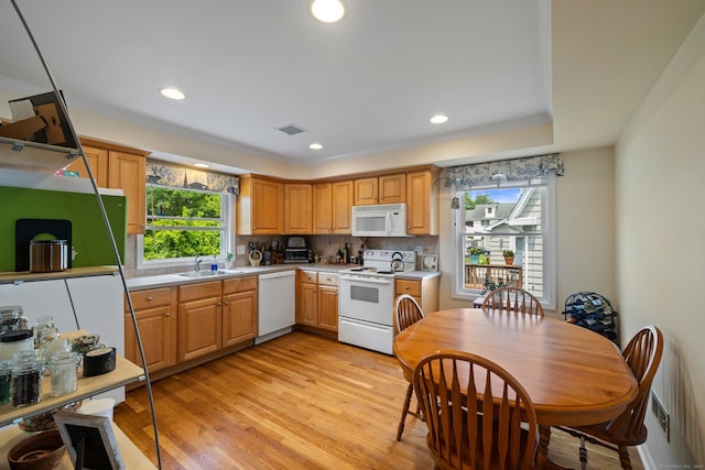 17 Glenwood Ave, Norwalk, CT 06854 - kitchen featuring white appliances, healthy amount of natural light, light countertops, tasteful backsplash, and recessed lighting