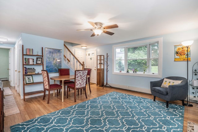 244 Stanwood Dr, New Britain, CT 06053 - dining area with a baseboard radiator, stairway, a ceiling fan, wood finished floors, and a baseboard heating unit