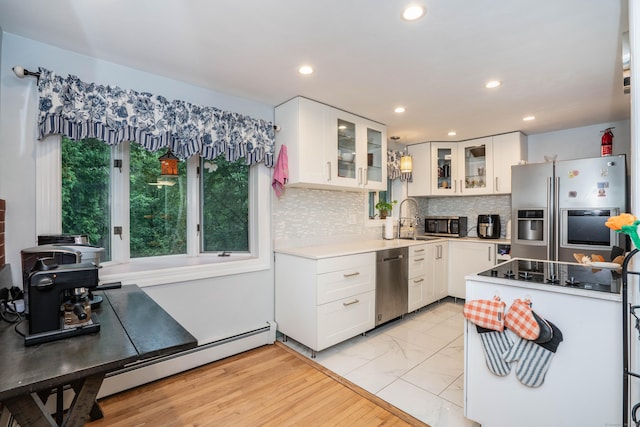 244 Stanwood Dr, New Britain, CT 06053 - kitchen with stainless steel appliances, light countertops, decorative backsplash, glass insert cabinets, and light marble finish flooring